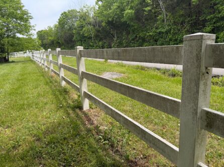Dirty vinyl ranch fence before pressure washing